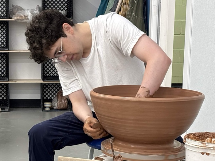 Drew Leivan throwing a bowl on a pottery wheel